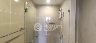 Modern bathroom with glass shower enclosure and sleek fixtures
