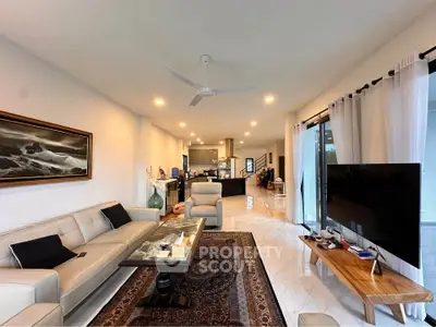 Spacious modern living room with elegant decor and open kitchen layout, perfect for entertaining.