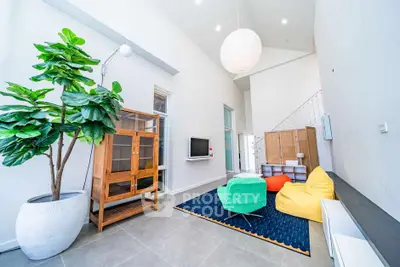 Modern living room with vibrant decor and high ceiling