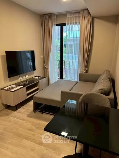 Modern living room with sleek furniture and large window for natural light.