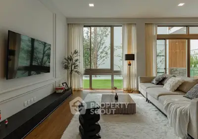 Luxurious modern living room with large windows and elegant decor