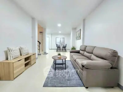 Spacious living room with modern sofa and dining area in open layout