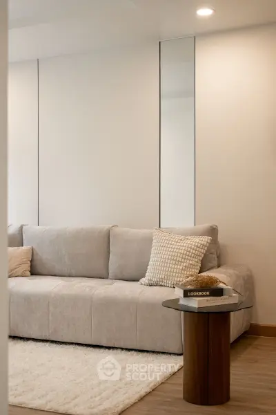 Modern living room with plush sofa and stylish decor, perfect for relaxation and comfort.