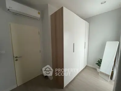 Modern bedroom with sleek wardrobe and air conditioning unit