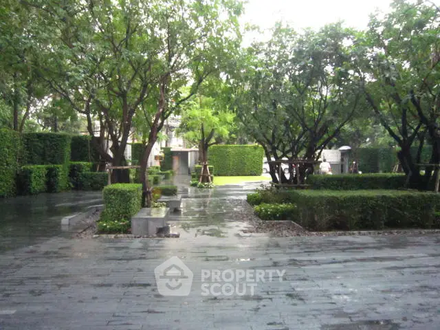 Lush green garden with paved pathways in a serene residential area