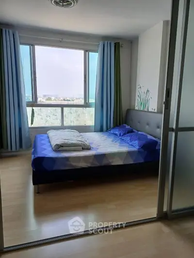Bright bedroom with large window and modern decor in urban apartment