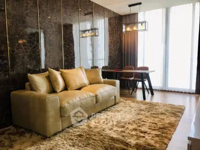 Luxurious living room with plush sofa and elegant dining area in modern apartment.