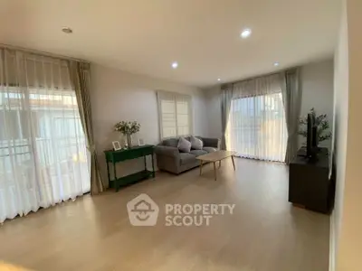 Spacious living room with modern decor and large windows for natural light.