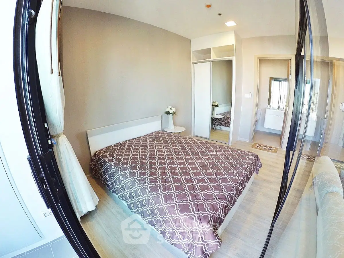 Modern bedroom with stylish decor and large mirror closet