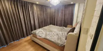 Spacious bedroom with elegant curtains and modern lighting