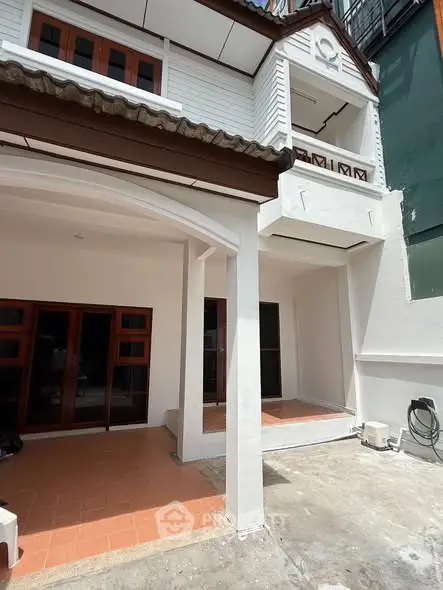 Charming two-story townhouse with spacious balcony and modern exterior design.