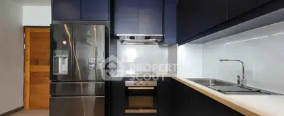 Modern kitchen with sleek black cabinets and stainless steel appliances