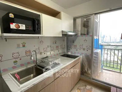 Charming kitchen with playful decor and balcony view in modern apartment.