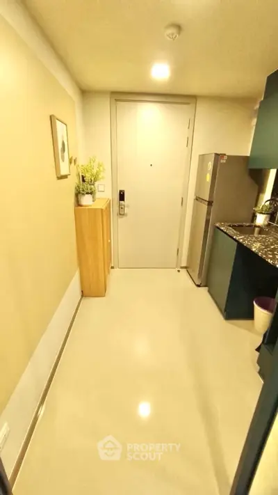 Modern apartment entrance with sleek kitchen and stylish decor