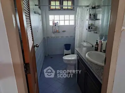 Cozy bathroom with modern fixtures and ample storage space, perfect for a comfortable living experience.