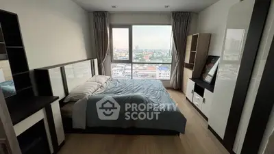 Modern bedroom with city view, featuring stylish furniture and large window for natural light.