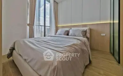 Luxurious bedroom with floor-to-ceiling windows and elegant decor in modern apartment.