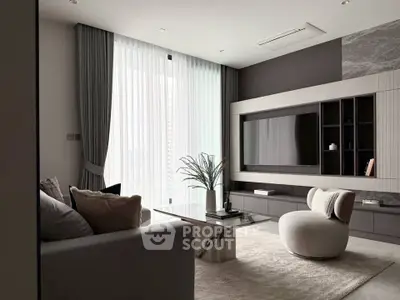 Modern living room with stylish furniture and large TV, featuring elegant curtains and a marble coffee table.