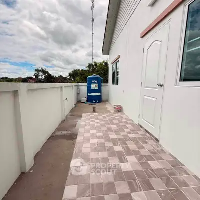 Spacious outdoor balcony with tiled flooring and scenic views, perfect for relaxation and outdoor activities.