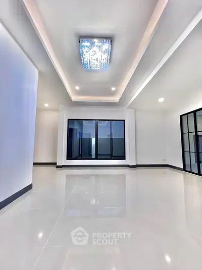 Spacious modern living room with elegant lighting and large windows