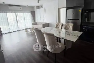 Modern living room with elegant dining area and large windows