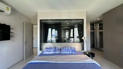 Modern bedroom with large window and city view, featuring sleek design and ample natural light.