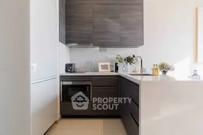 Modern kitchen with sleek dark cabinets and built-in appliances