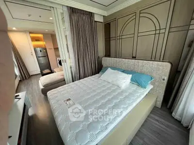 Modern bedroom with elegant design and adjacent kitchenette in a stylish apartment.