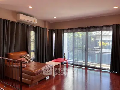 Spacious living room with large windows and modern decor