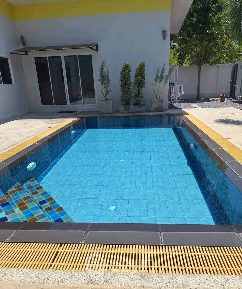 Stunning private pool with modern design in a serene residential setting, perfect for relaxation and entertainment.