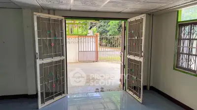 Spacious entrance with open doors leading to a private outdoor area, perfect for relaxation.