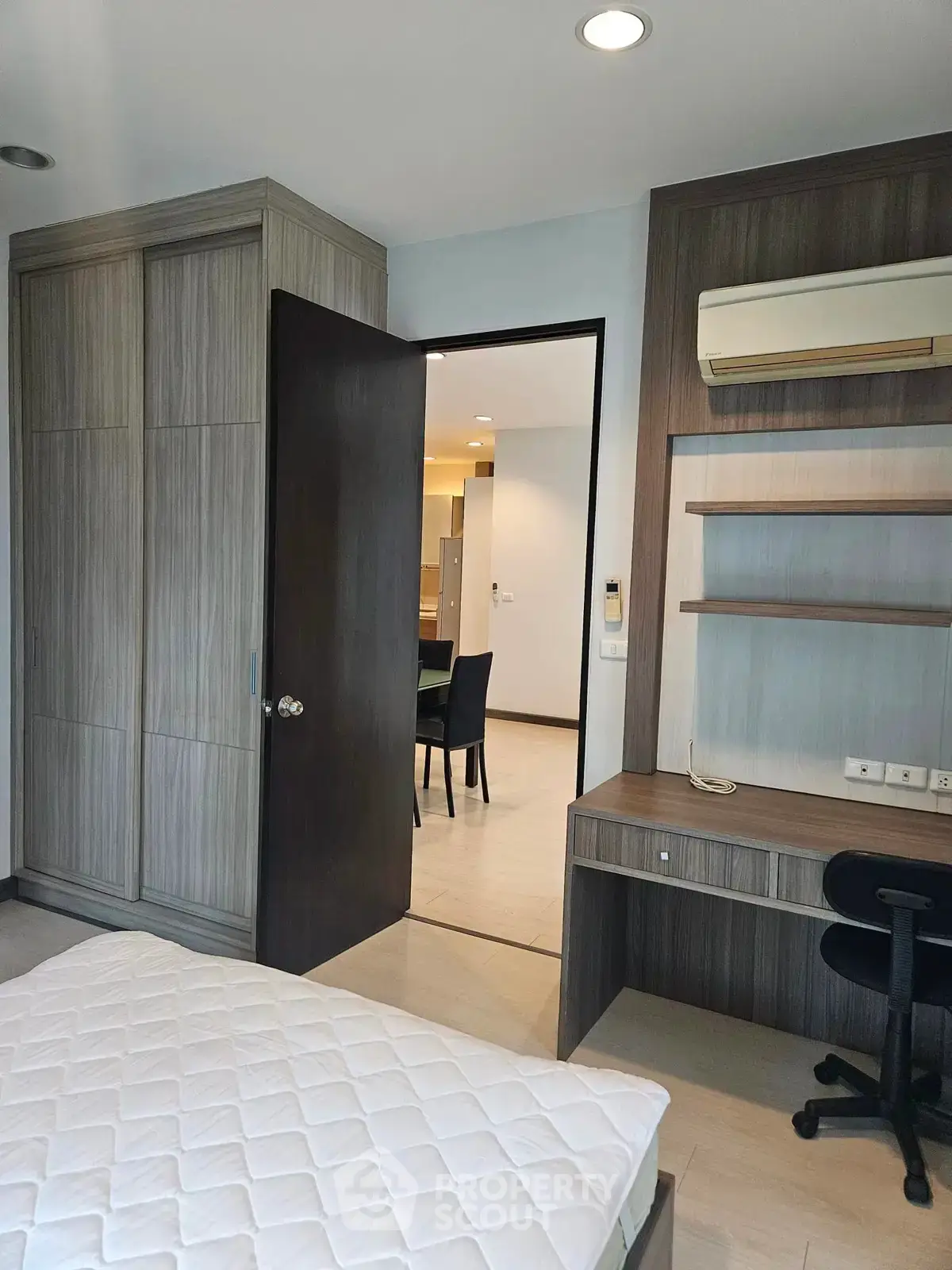 Spacious bedroom with built-in wardrobe and study desk, ideal for modern living.