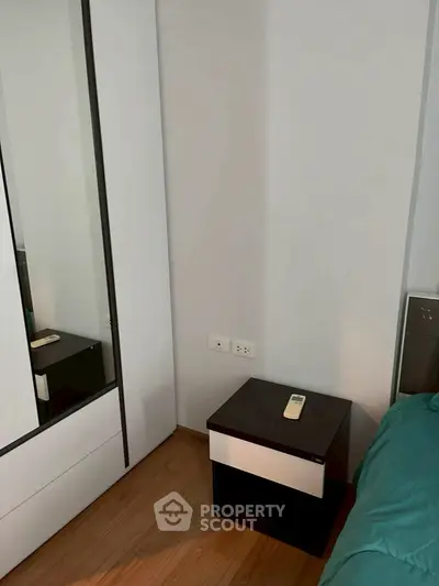 Modern bedroom with sleek wardrobe and nightstand in minimalist design