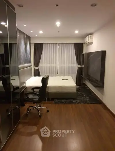 Modern bedroom with sleek design and hardwood floors