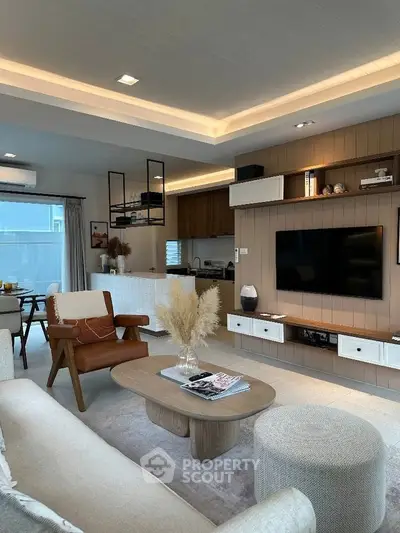 Modern living room with stylish furniture and open kitchen layout, perfect for entertaining.