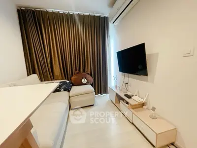 Cozy living room with modern decor and wall-mounted TV, perfect for relaxation.