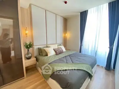 Elegant bedroom with modern decor and large window for natural light