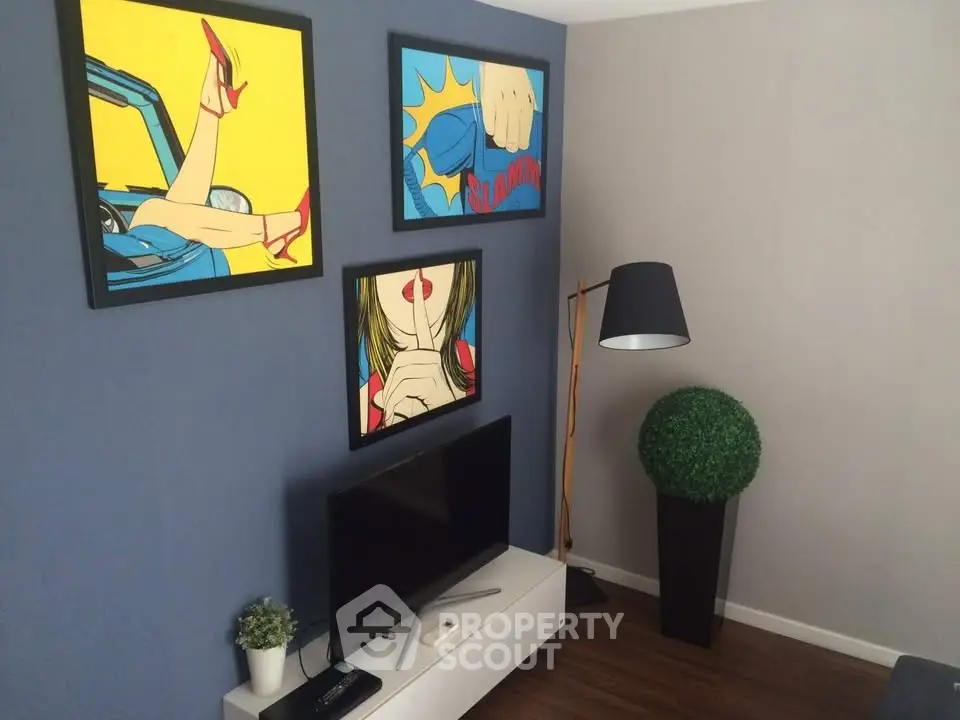 Stylish living room with modern decor and pop art paintings on the wall.