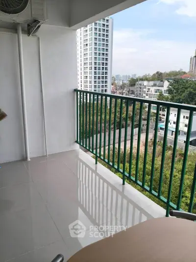 Spacious balcony with city view in modern high-rise apartment
