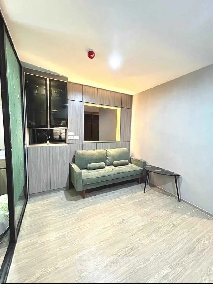 Modern living room with stylish sofa and wooden flooring in a cozy apartment.