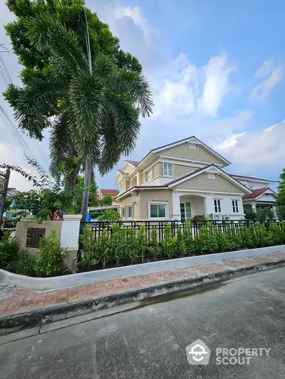 Charming two-story house with lush garden and spacious driveway in serene neighborhood.