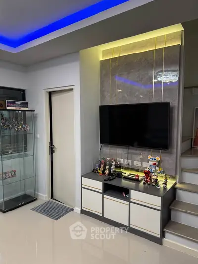 Modern living room with sleek TV setup and ambient lighting