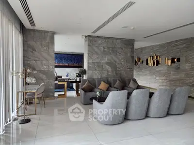 Luxurious modern living room with elegant gray furniture and stylish decor in a spacious open layout.