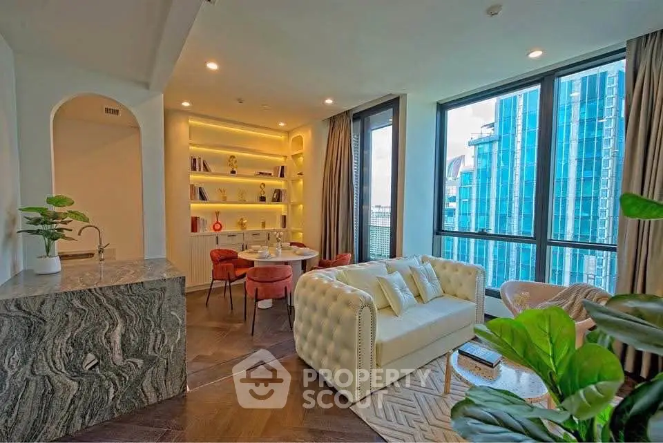 Luxurious modern living room with large windows and elegant decor in a high-rise apartment.