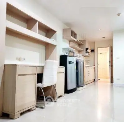 Modern kitchen with sleek appliances and ample storage in a stylish apartment.