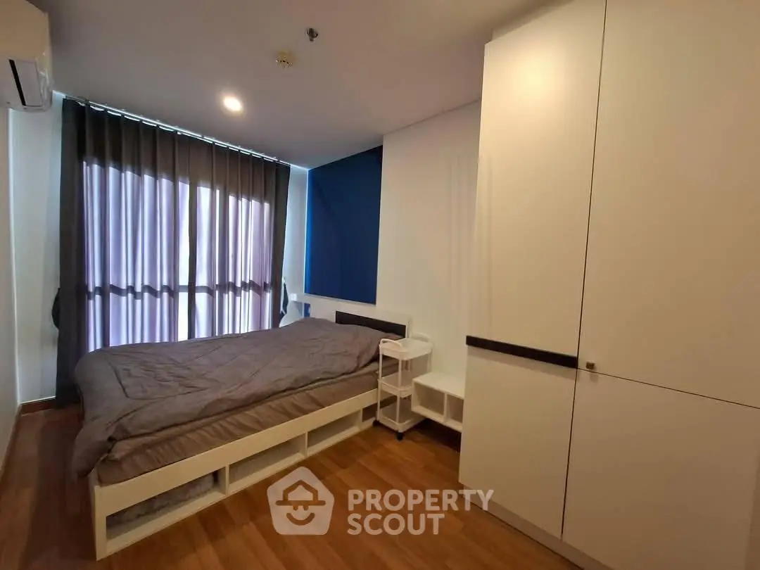 Modern bedroom with sleek design and ample storage in a stylish apartment.