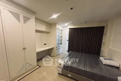 Spacious bedroom with modern furnishings and ample storage in a stylish apartment.