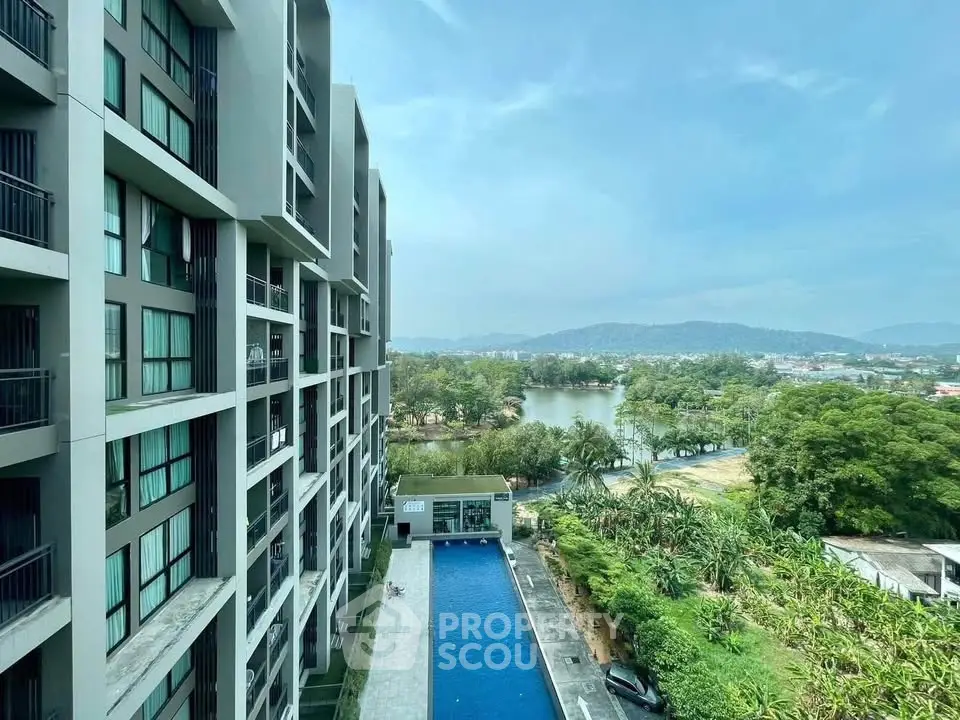 Modern apartment building with pool and scenic mountain view