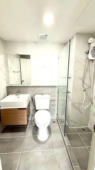 Modern bathroom with sleek fixtures and glass shower enclosure