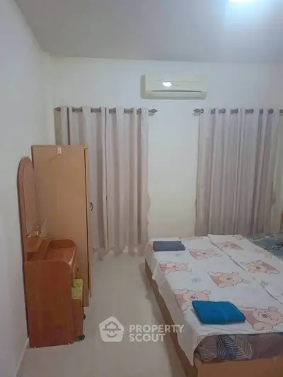 Cozy bedroom with air conditioning and charming decor, perfect for restful nights.